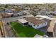 Aerial view of a fenced backyard with lush lawn, covered patio, and well-maintained surroundings at 2310 W Stella Ln, Phoenix, AZ 85015