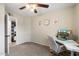 This carpeted bedroom features a ceiling fan and a well-lit workspace at 2310 W Stella Ln, Phoenix, AZ 85015