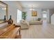 Bright living room with a piano, light wood floors, comfortable seating, and a decorative painting at 23327 S 222Nd St, Queen Creek, AZ 85142