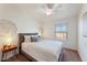 This well-lit bedroom features neutral decor, a ceiling fan, and a comfortable bed at 2402 E 5Th St # 1521, Tempe, AZ 85288