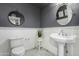 Bathroom featuring gray walls, white wainscoting, and a pedestal sink at 26 W Rawhide Ave, Gilbert, AZ 85233