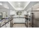 Updated kitchen featuring modern appliances, granite countertops, and white cabinetry at 26 W Rawhide Ave, Gilbert, AZ 85233