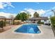 Refreshing pool surrounded by a patio, manicured greenery, and a charming pergola, creating a serene outdoor space at 26 W Rawhide Ave, Gilbert, AZ 85233