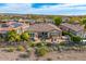 Aerial shot showcases the home's backyard with outdoor seating, spa, and well-maintained landscaping at 29412 N 128Th Ln, Peoria, AZ 85383