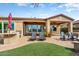 Inviting backyard features a covered patio, built-in grill, lounge chairs, and a tranquil spa at 29412 N 128Th Ln, Peoria, AZ 85383