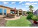Backyard oasis featuring an outdoor kitchen, putting green and desert landscaping at 29412 N 128Th Ln, Peoria, AZ 85383