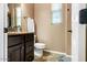 Powder room featuring neutral paint, granite counters, and a window for natural light at 29412 N 128Th Ln, Peoria, AZ 85383