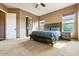 Comfortable bedroom with a king-size bed, carpet, and windows at 29412 N 128Th Ln, Peoria, AZ 85383