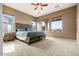 Spacious primary bedroom with neutral carpet, and three windows at 29412 N 128Th Ln, Peoria, AZ 85383