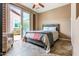 Bright bedroom features a king-size bed, and a sliding glass door at 29412 N 128Th Ln, Peoria, AZ 85383