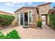 Private patio with stone detail, sliding door entrance, and lush surrounding greenery at 29412 N 128Th Ln, Peoria, AZ 85383