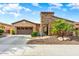 Charming single-story home featuring a stone accent wall, well-manicured landscaping, and a two-car garage at 29412 N 128Th Ln, Peoria, AZ 85383