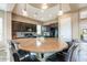 Beautiful kitchen with dark cabinetry, granite countertops, a central island, and modern appliances at 29412 N 128Th Ln, Peoria, AZ 85383