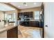 Well-lit kitchen features dark cabinetry, granite countertops, and modern appliances at 29412 N 128Th Ln, Peoria, AZ 85383