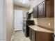 Laundry room with washer, dryer, overhead cabinets, and a folding counter at 29412 N 128Th Ln, Peoria, AZ 85383