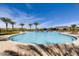 Large community pool surrounded by palm trees and lounge chairs, offering a relaxing outdoor space at 29412 N 128Th Ln, Peoria, AZ 85383