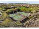 Aerial view of well-maintained tennis courts in a desert setting, showcasing a recreational amenity at 29412 N 128Th Ln, Peoria, AZ 85383