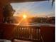 Balcony view of a community pool with lounge chairs under a vibrant sunset sky in a relaxing atmosphere at 3031 N Civic Center Plz # 261, Scottsdale, AZ 85251