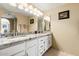 Bright bathroom featuring dual sinks, granite counters, and arched mirror at 3031 N Civic Center Plz # 261, Scottsdale, AZ 85251