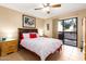 Comfortable bedroom with ceiling fan, sliding glass doors, and tile flooring at 3031 N Civic Center Plz # 261, Scottsdale, AZ 85251