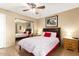 Comfortable bedroom featuring ceiling fan, mirrored closet, and tile flooring at 3031 N Civic Center Plz # 261, Scottsdale, AZ 85251
