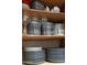 A cabinet stocked with glassware and dinnerware, featuring wine glasses, plates, and bowls at 3031 N Civic Center Plz # 261, Scottsdale, AZ 85251