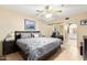Cozy main bedroom features a comfortable bed, ceiling fan, and an en-suite bathroom for added convenience at 3031 N Civic Center Plz # 261, Scottsdale, AZ 85251