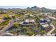 Stunning aerial view of a desert home with a meticulously landscaped yard and mountain backdrop at 3101 E Acoma Dr, Phoenix, AZ 85032