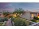 Scenic backyard view showcasing professional landscaping, terraced planting beds and charming exterior architecture at 3101 E Acoma Dr, Phoenix, AZ 85032