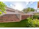 Beautiful backyard featuring synthetic grass, brick stairs, and mature landscaping for outdoor enjoyment at 3101 E Acoma Dr, Phoenix, AZ 85032