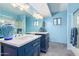 Bright blue bathroom featuring dual sink vanity with white countertop and decorative vase at 3101 E Acoma Dr, Phoenix, AZ 85032