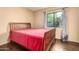 Bright bedroom featuring hardwood floors, a large window, and neutral decor at 3101 E Acoma Dr, Phoenix, AZ 85032