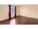 Cozy bedroom with hardwood floors, a window, and neutral wall decor at 3101 E Acoma Dr, Phoenix, AZ 85032
