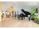 Open living room with a grand piano, tile flooring, and high ceilings, ideal for entertaining at 3101 E Acoma Dr, Phoenix, AZ 85032