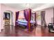 Spacious main bedroom features a canopy bed, hardwood floors, and archway to large closet at 3101 E Acoma Dr, Phoenix, AZ 85032