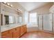 Bright bathroom featuring double sinks, soaking tub, and walk-in shower at 3325 N 116Th Dr, Avondale, AZ 85392