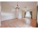 Bright living room with tile flooring, chandelier, ceiling fan, and ample natural light at 3325 N 116Th Dr, Avondale, AZ 85392