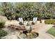 Backyard features a stone fountain, brick-lined beds, tiered seating, and mature hedges for privacy at 34 W Vernon Ave, Phoenix, AZ 85003