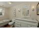 Classic bathroom with clawfoot tub, marble vanity, elegant mirror and fixtures, and wood paneled walls at 34 W Vernon Ave, Phoenix, AZ 85003