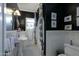 Elegant black-and-white bathroom featuring a pedestal sink, patterned tile floor, and classic design elements at 34 W Vernon Ave, Phoenix, AZ 85003