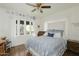 Cozy bedroom with large windows, hardwood floors and a comfortable blue patterned quilt at 34 W Vernon Ave, Phoenix, AZ 85003