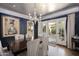 Stylish dining area with chic chandelier, opens to a serene outdoor space through french doors at 34 W Vernon Ave, Phoenix, AZ 85003