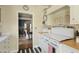 Bright kitchen with stainless steel appliances, white cabinetry and decorative tile and checkered accents at 34 W Vernon Ave, Phoenix, AZ 85003