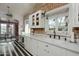 Bright kitchen features a farmhouse sink, butcher block counters and exposed brick walls at 34 W Vernon Ave, Phoenix, AZ 85003