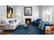 Bright living room features a fireplace, hardwood floors, and ample natural light from large windows at 34 W Vernon Ave, Phoenix, AZ 85003