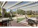 Inviting outdoor patio with pergola, striped curtains, dining set, lounge chairs and fountain for relaxing and entertaining at 34 W Vernon Ave, Phoenix, AZ 85003