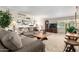 Inviting living room with large gray sofa, wooden coffee table, and plush carpet at 3511 N Miller Rd, Scottsdale, AZ 85251