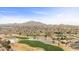 Expansive aerial view of community with a golf course and scenic mountain backdrop at 3716 E Andre Ave, Gilbert, AZ 85298