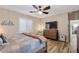Bedroom with hardwood floors, ceiling fan, plantation shutters and a comfortable bed with a wooden dresser at 3716 E Andre Ave, Gilbert, AZ 85298