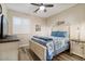 Cozy bedroom featuring a ceiling fan, wood-look floors, and warm neutral walls at 3716 E Andre Ave, Gilbert, AZ 85298